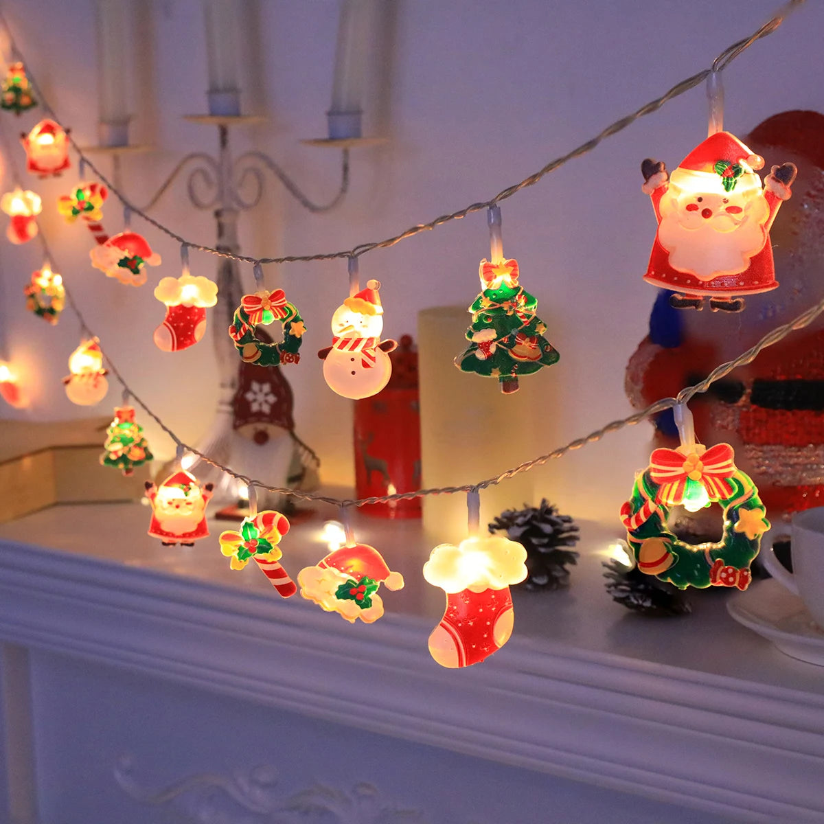 LED Christmas string lights with Santa, snowman, candy cane, stocking, and snowflake designs for indoor trees and holiday decor.