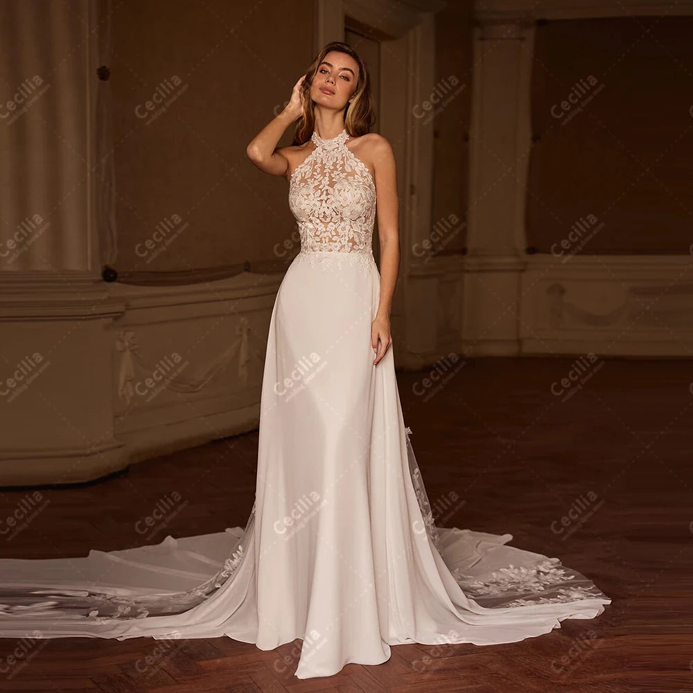 Elegant satin wedding dress featuring a halter neck and detailed lace appliques, perfect for a romantic and modern bridal look.